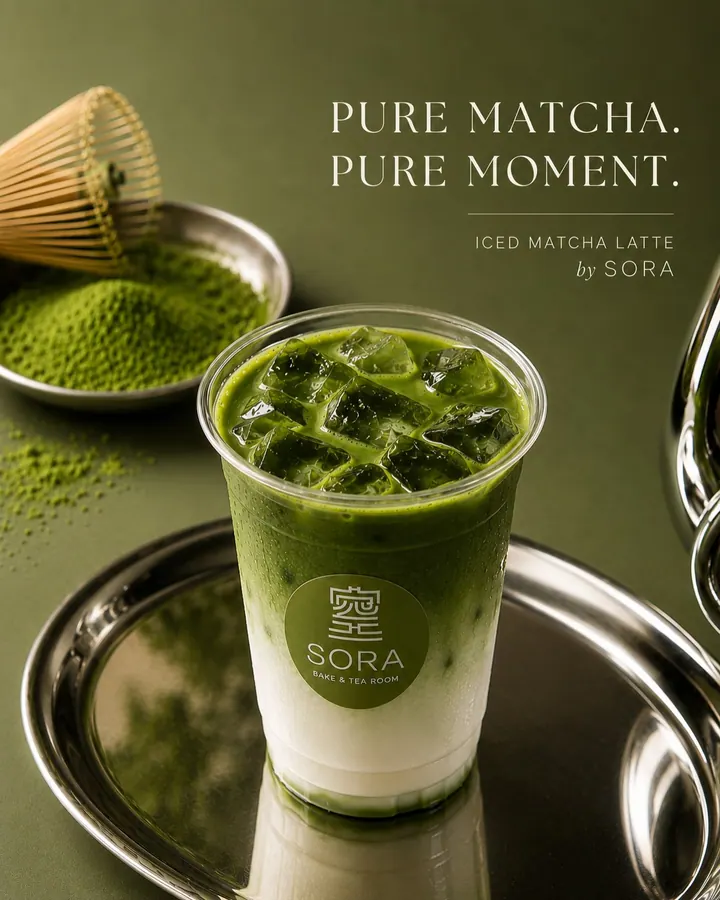 Iced matcha latte with Sora logo, matcha powder, and bamboo whisk
