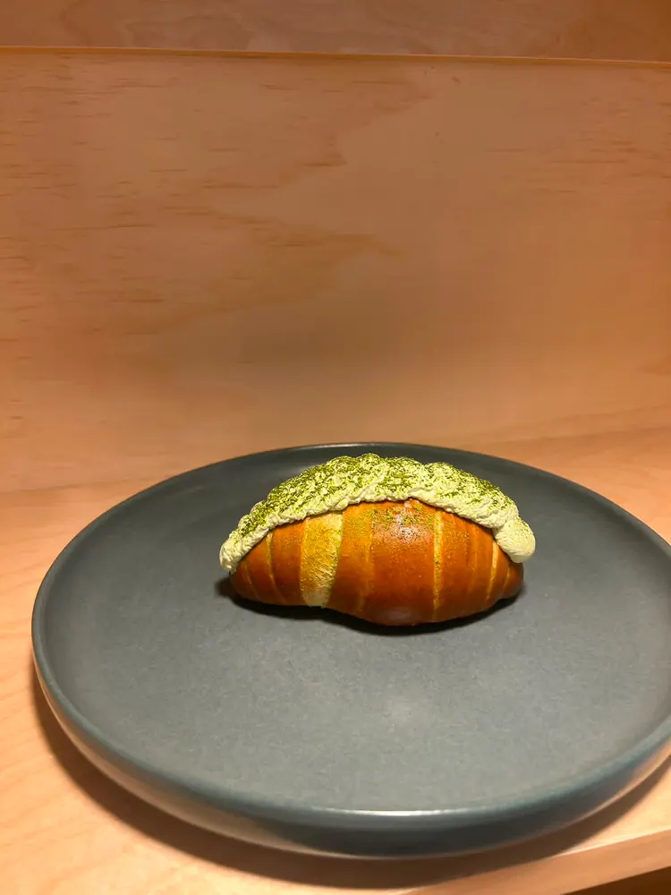 Golden salt bread topped with matcha cream at Sora Bake & Tea Room